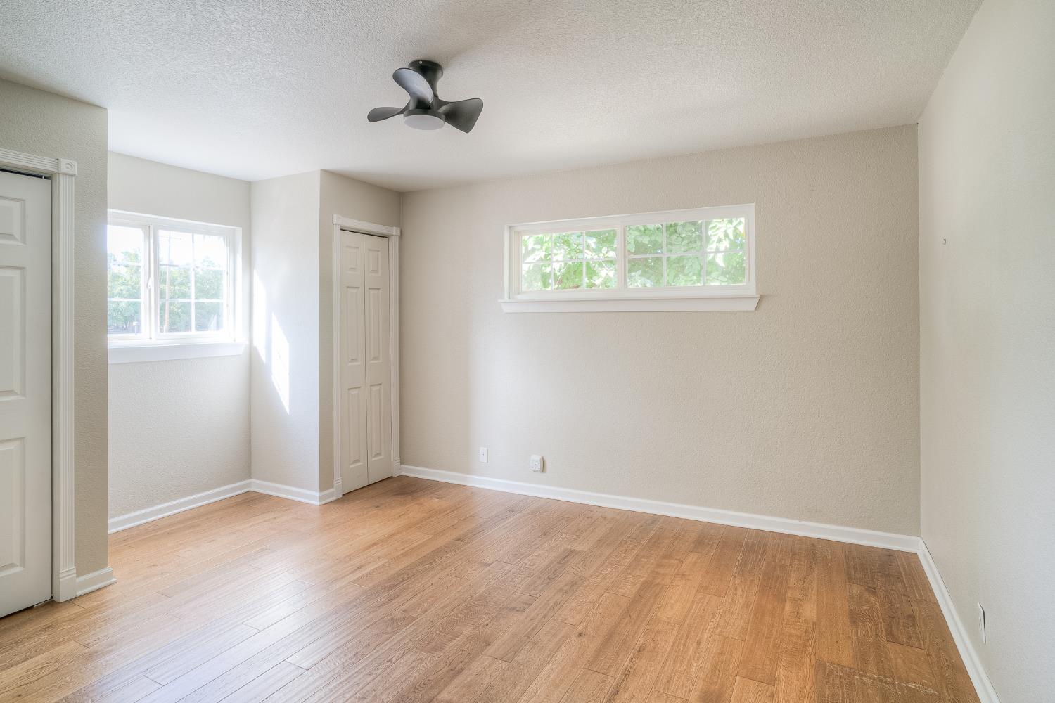 5463 Hankins Road Williams, CA 95987 - Photo 18 of 62 an empty room with wooden floor and windows