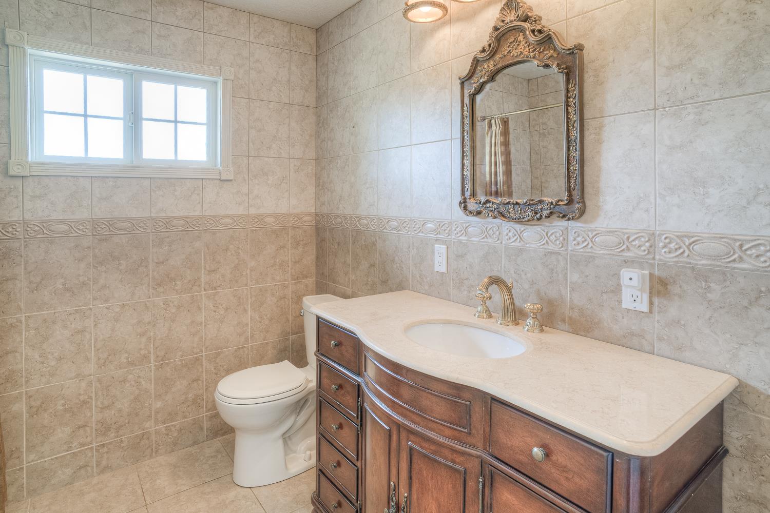 5463 Hankins Road Williams, CA 95987 - Photo 24 of 62 a bathroom with a sink vanity mirror and toilet