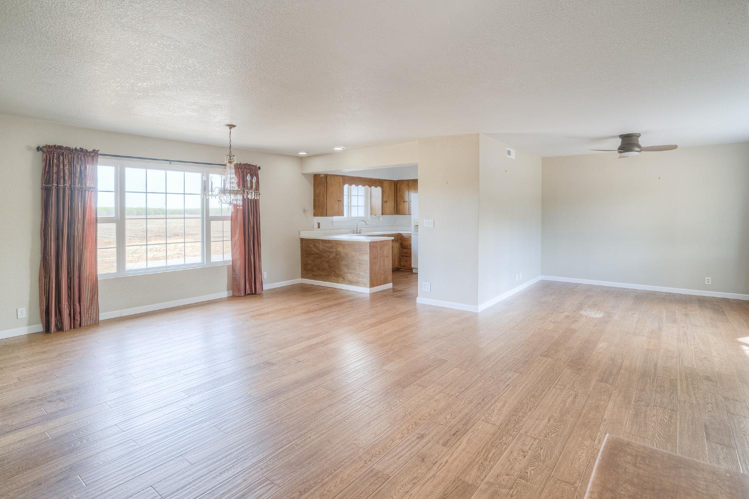 5463 Hankins Road Williams, CA 95987 - Photo 26 of 62 an empty room with wooden floor and windows