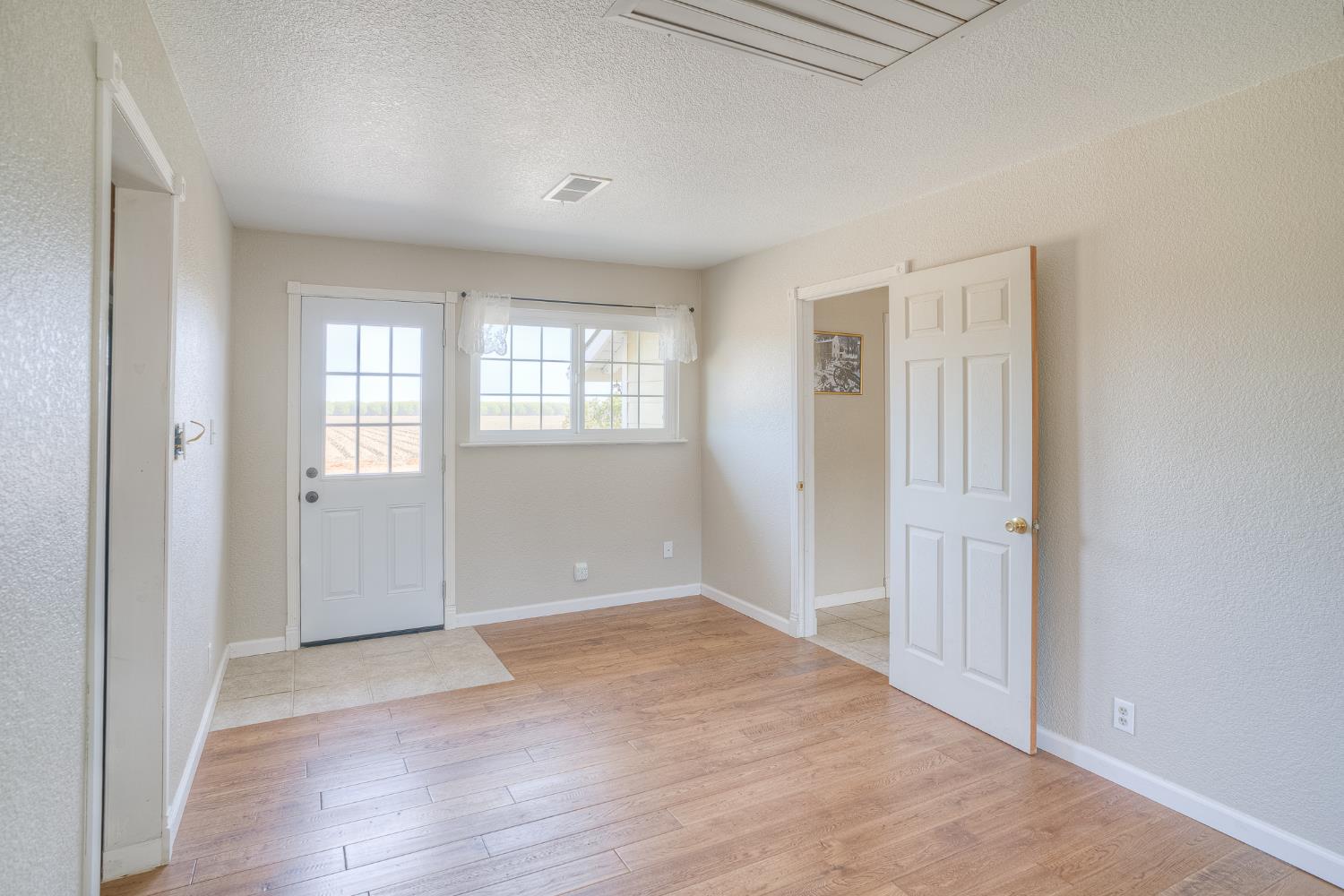5463 Hankins Road Williams, CA 95987 - Photo 28 of 62 an empty room with wooden floor and windows