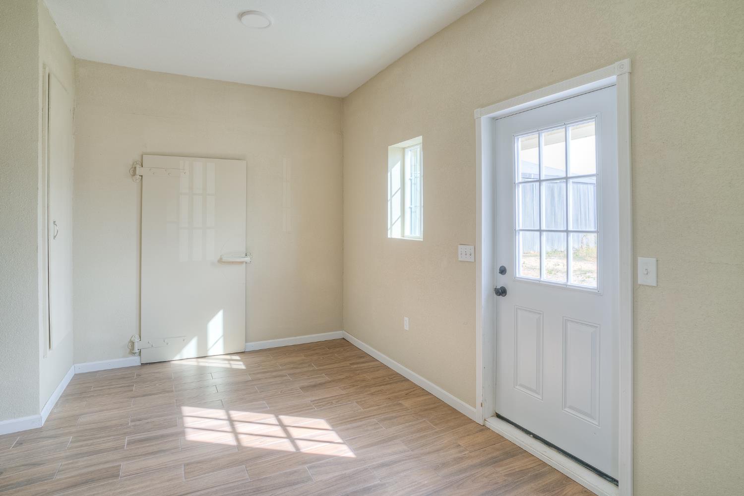 5463 Hankins Road Williams, CA 95987 - Photo 38 of 62 an empty room with wooden floor and windows