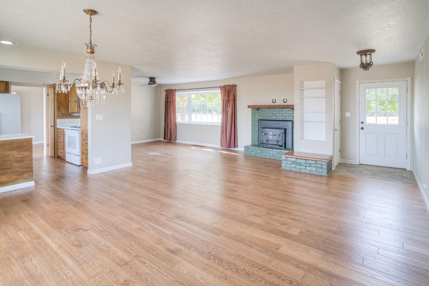 5463 Hankins Road Williams, CA 95987 - Photo 5 of 62 a view of a livingroom with wooden floor fireplace and window
