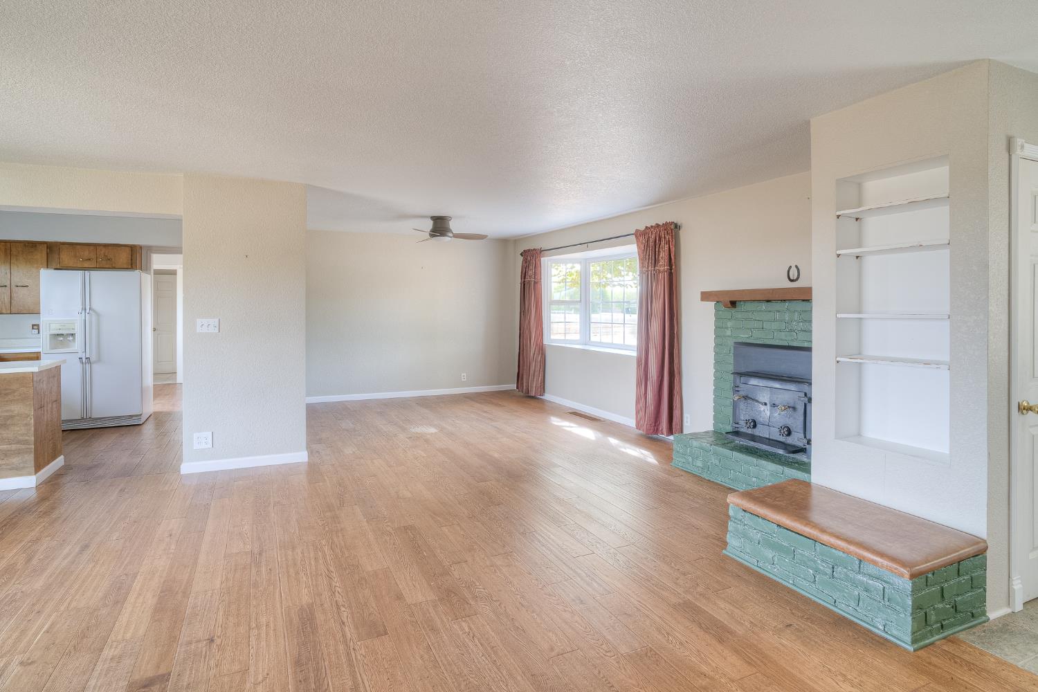 5463 Hankins Road Williams, CA 95987 - Photo 7 of 62 wooden floor in an empty room with a fireplace