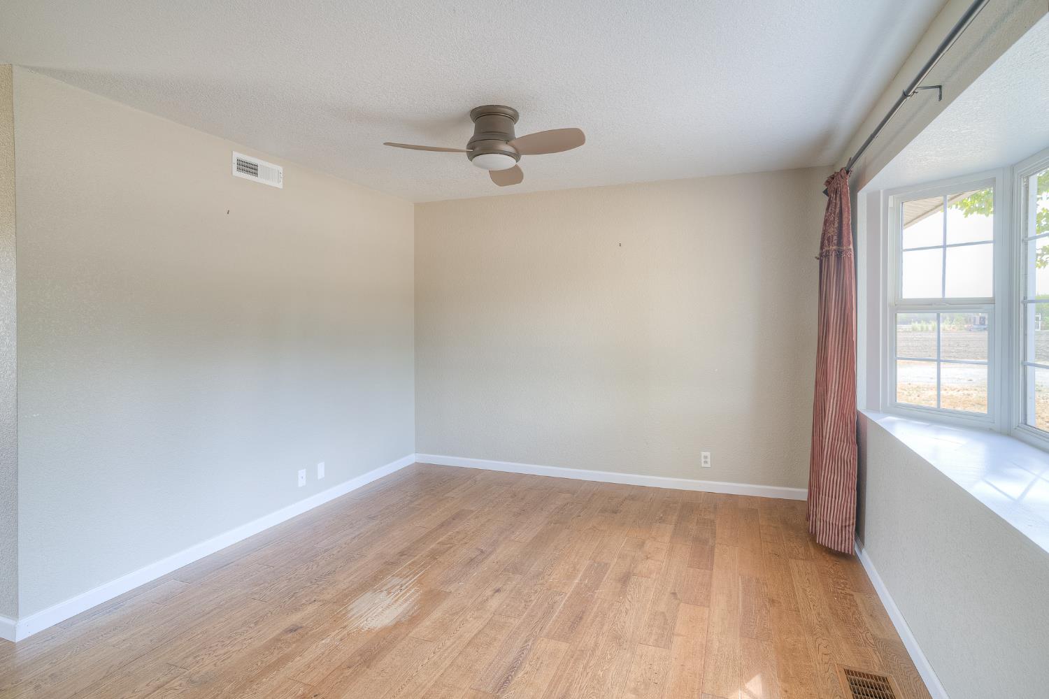 5463 Hankins Road Williams, CA 95987 - Photo 8 of 62 wooden floor in an empty room with a window