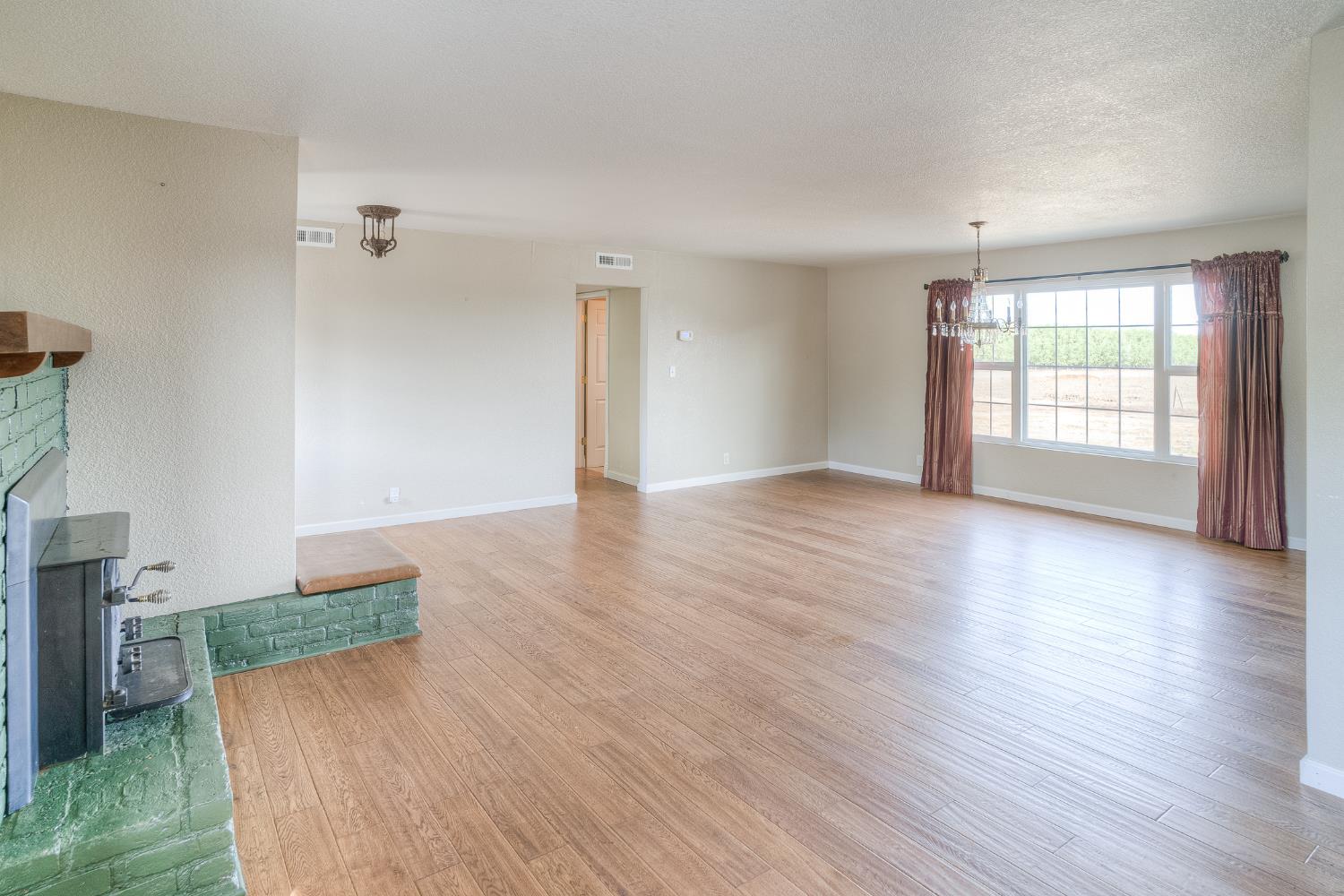 5463 Hankins Road Williams, CA 95987 - Photo 9 of 62 an empty room with wooden floor and windows