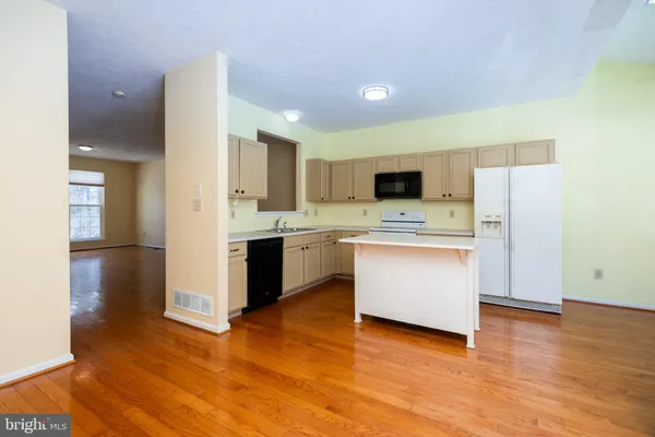 a kitchen with stainless steel appliances a refrigerator sink and microwave
