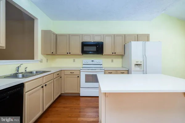 a kitchen with stainless steel appliances a stove sink and cabinets