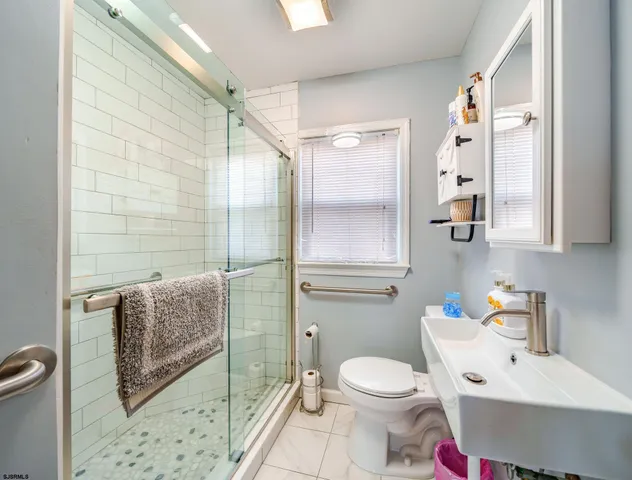 a bathroom with a toilet sink and shower