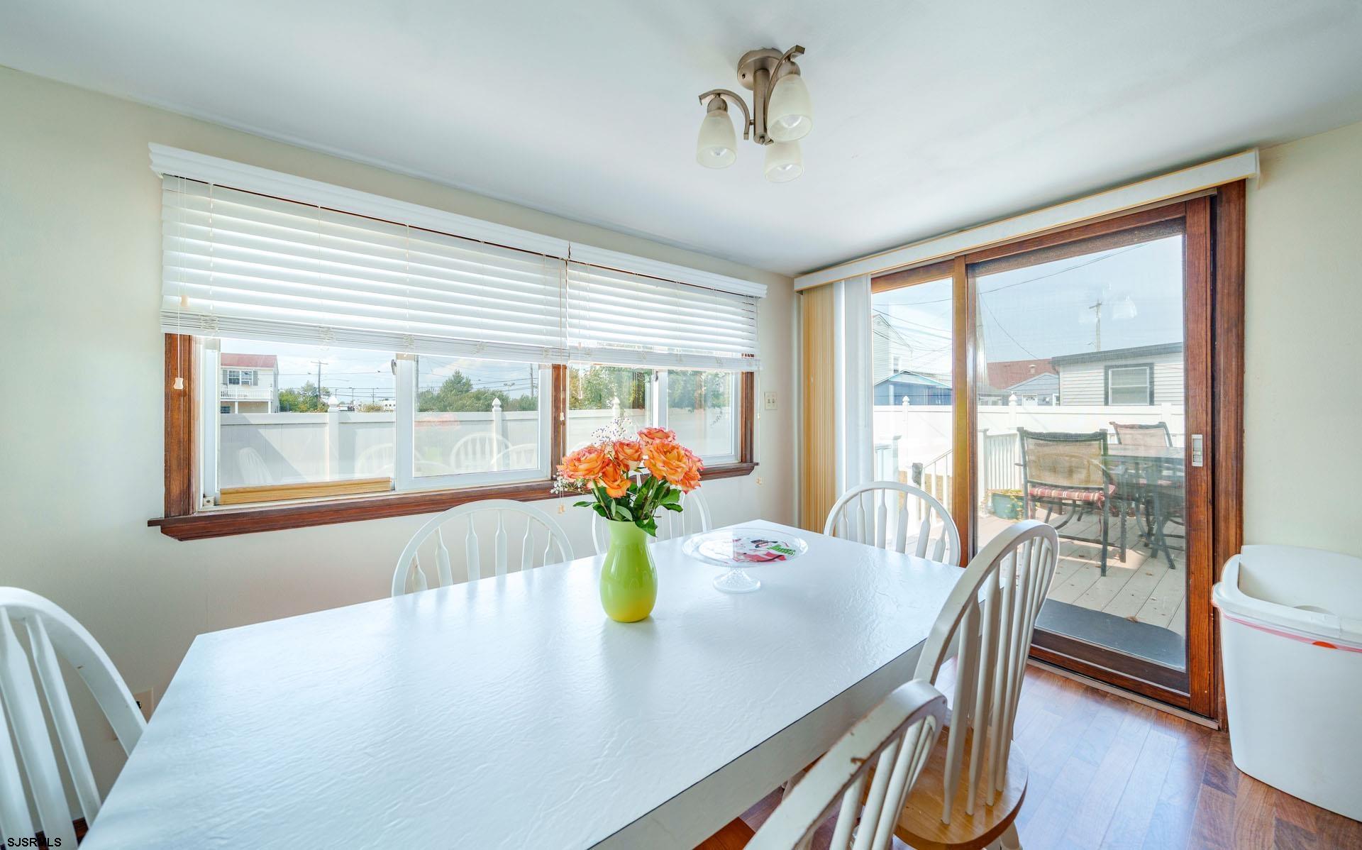 205 East Plaza Place Egg Harbor Township, NJ 08232 - Photo 15 of 31 a view of a dining room with furniture a potted plant and wooden floor