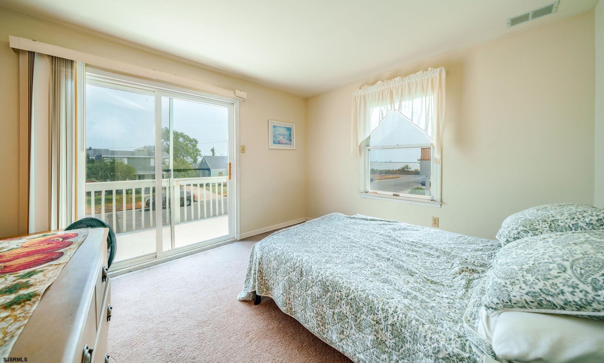 205 East Plaza Place Egg Harbor Township, NJ 08232 - Photo 22 of 31 a bedroom with a bed and glass window