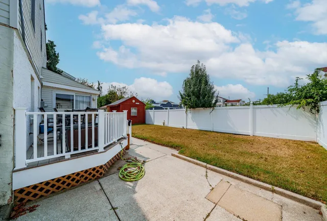 a view of a backyard with sitting area