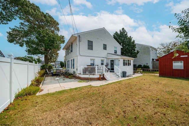 a view of a house with snow on the side of the road