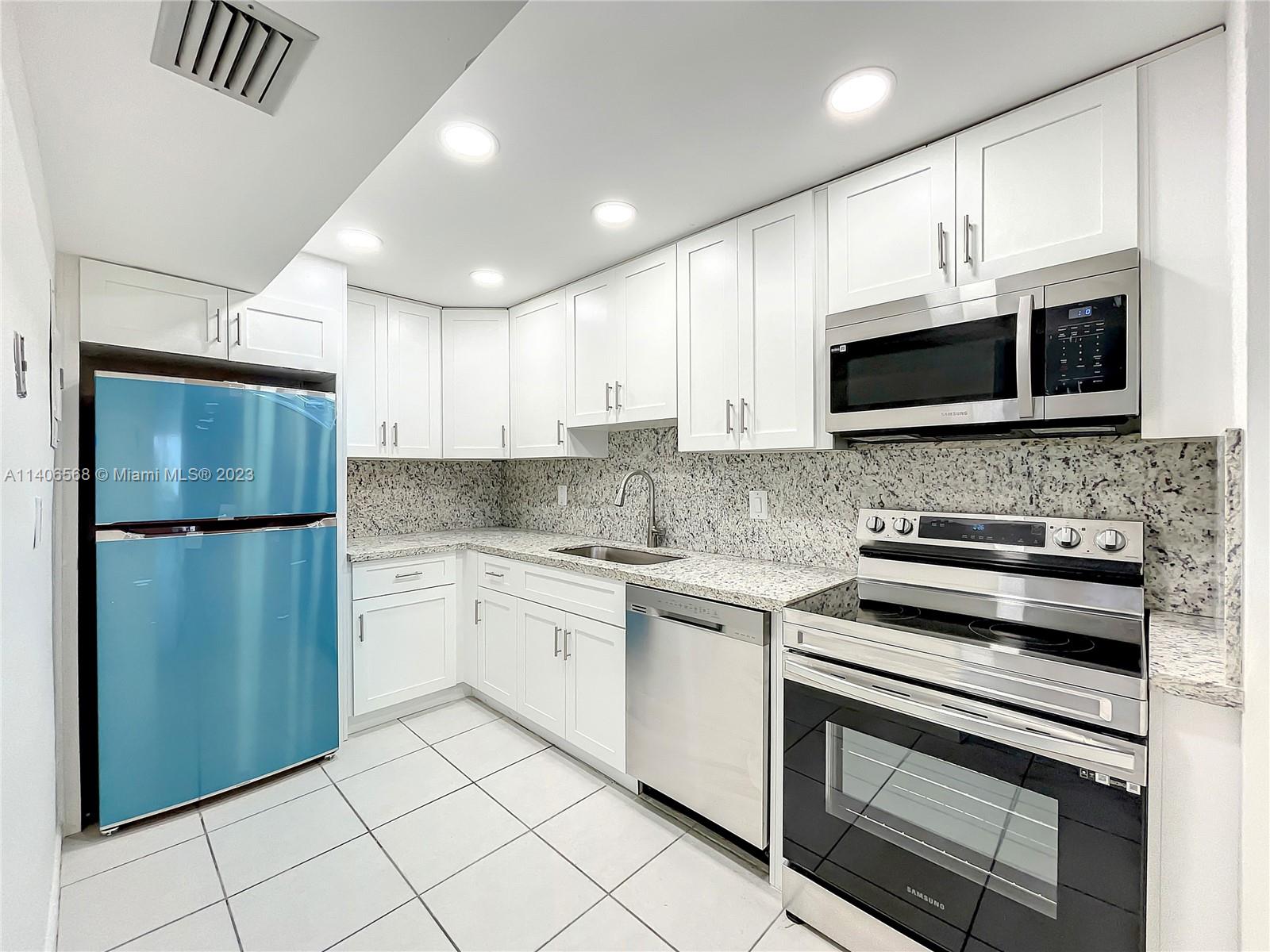 320 South Surf Road, Unit 502 Hollywood, FL 33019 - Photo 15 of 45 a kitchen with a sink stainless steel appliances and cabinets