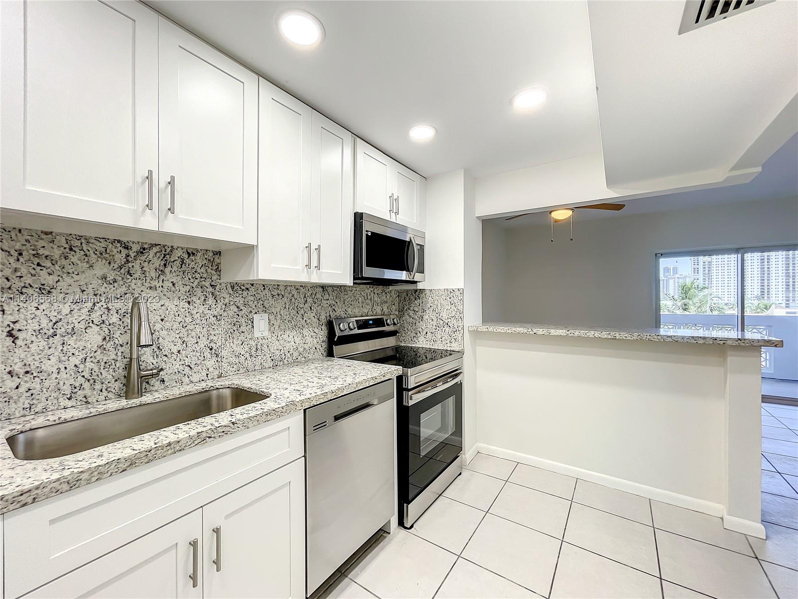 320 South Surf Road, Unit 502 Hollywood, FL 33019 - Photo 16 of 45 a kitchen with a sink cabinets and appliances