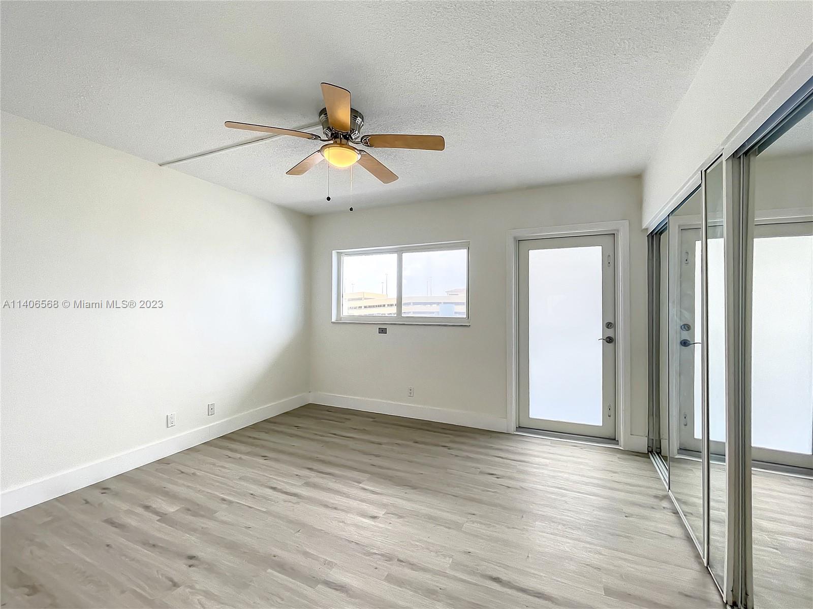 320 South Surf Road, Unit 502 Hollywood, FL 33019 - Photo 8 of 45 wooden floor in an empty room with a window