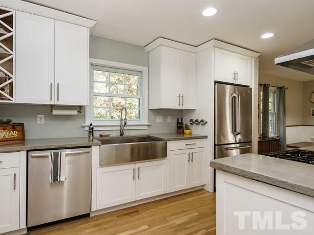 835 Brookside Drive Raleigh, NC 27604 - Photo 11 of 24 a kitchen with stainless steel appliances white cabinets a sink and a stove