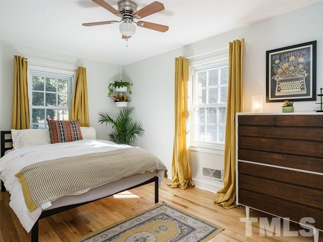 835 Brookside Drive Raleigh, NC 27604 - Photo 16 of 24 a bedroom with a bed and wooden floor