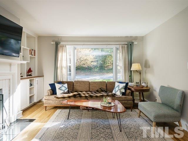 835 Brookside Drive Raleigh, NC 27604 - Photo 5 of 24 a living room with furniture and a flat screen tv