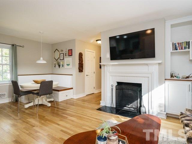 835 Brookside Drive Raleigh, NC 27604 - Photo 7 of 24 a living room with furniture a flat screen tv and a fireplace