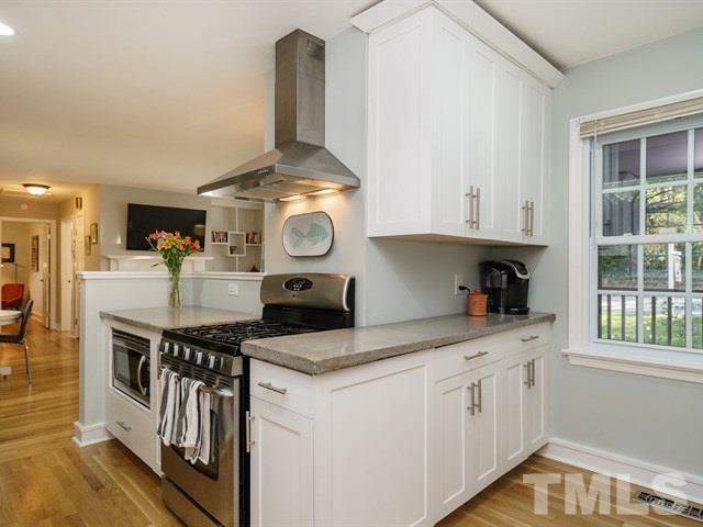 835 Brookside Drive Raleigh, NC 27604 - Photo 10 of 24 a kitchen with stainless steel appliances granite countertop a stove and a sink