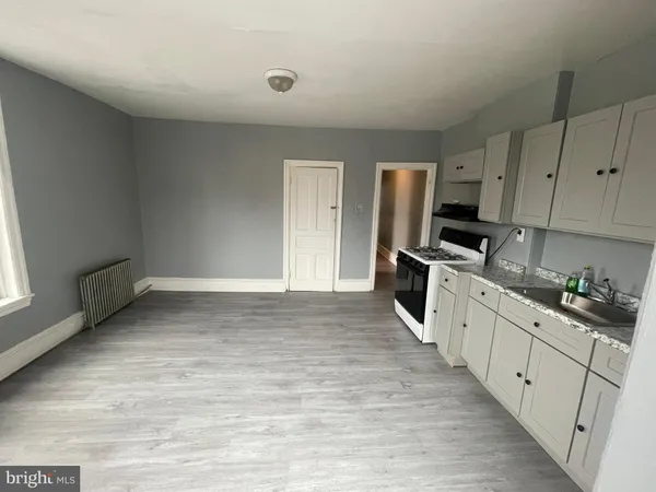 a kitchen with granite countertop a stove and a refrigerator