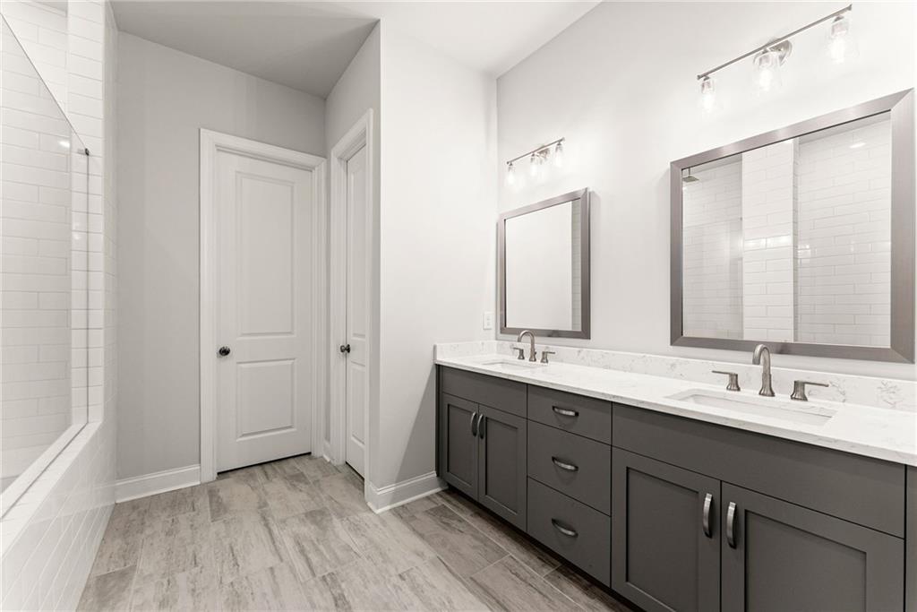 504 Pearl Street Cumming, GA 30040 - Photo 29 of 52 a bathroom with a double vanity sink and mirror