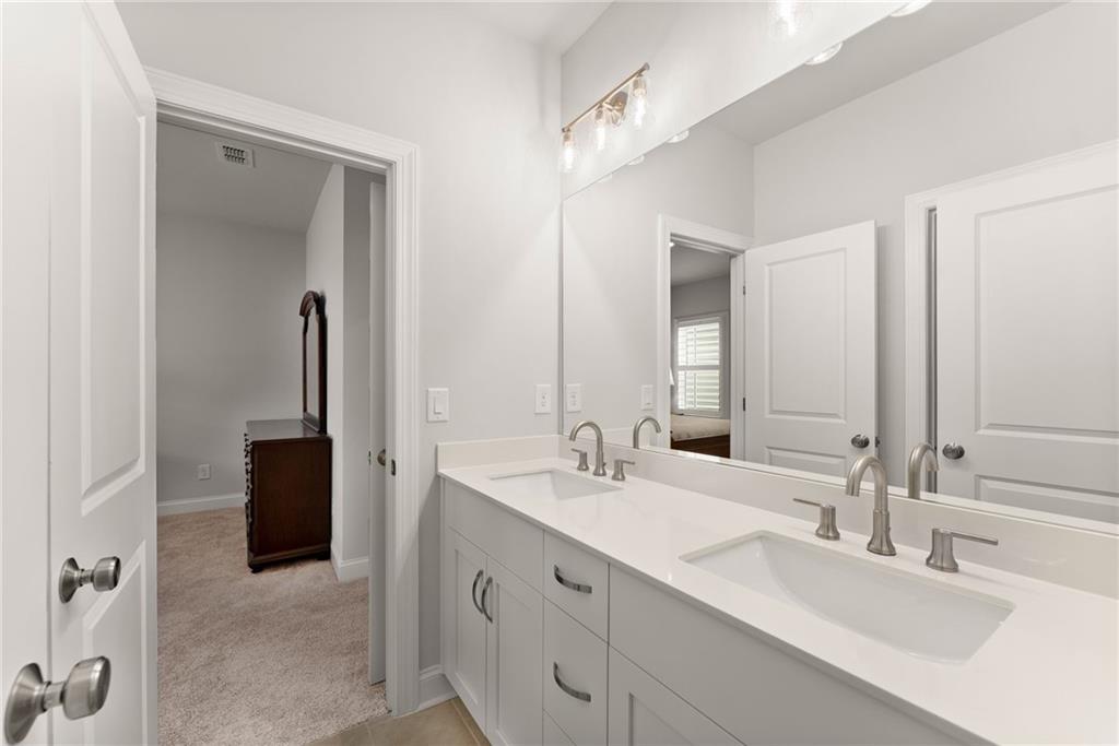 504 Pearl Street Cumming, GA 30040 - Photo 33 of 52 a bathroom with 2 sink and a mirror