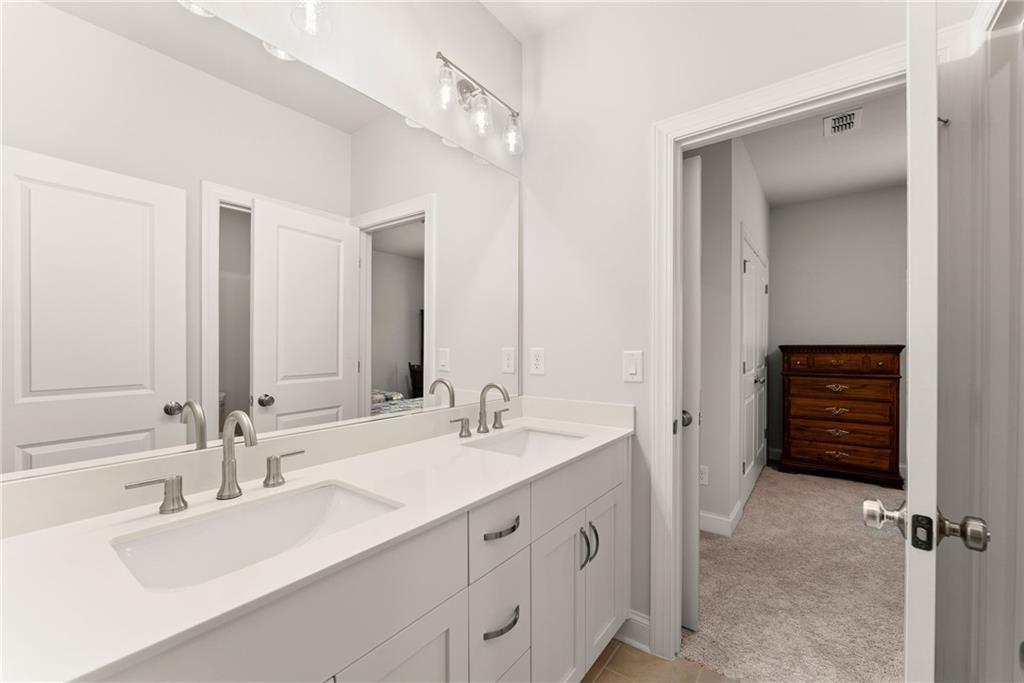 504 Pearl Street Cumming, GA 30040 - Photo 34 of 52 a bathroom with a sink tub vanity and a mirror