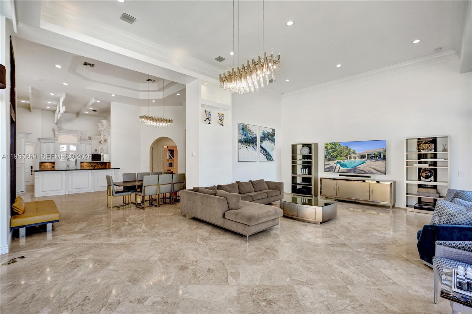 3175 Hunter Road Weston, FL 33331 - Photo 11 of 45 a living room with furniture and a chandelier