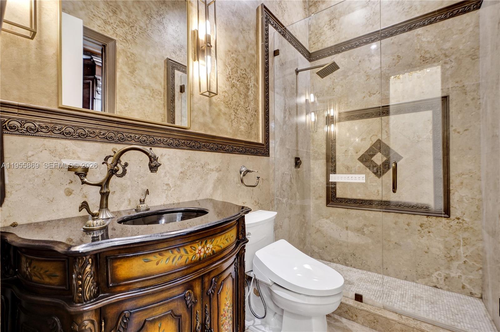 3175 Hunter Road Weston, FL 33331 - Photo 15 of 45 a bathroom with a sink a toilet and a mirror