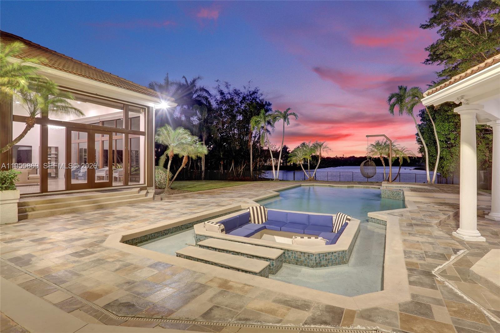 3175 Hunter Road Weston, FL 33331 - Photo 2 of 45 a view of a swimming pool with a lounge chair