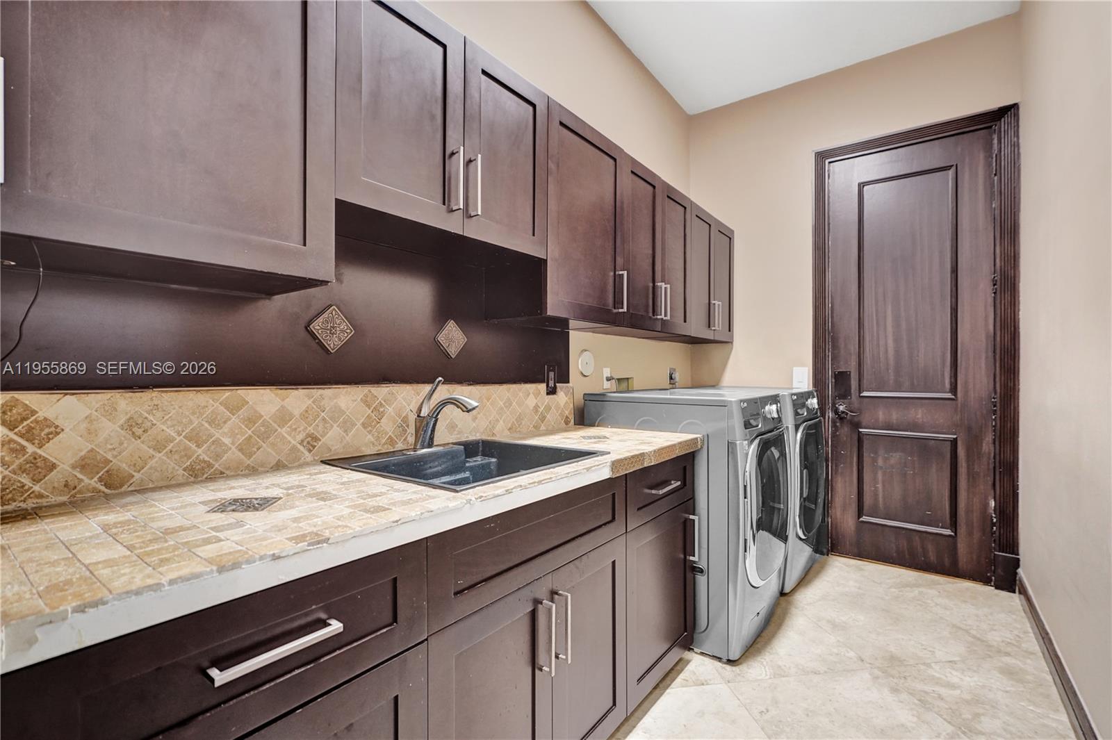 3175 Hunter Road Weston, FL 33331 - Photo 27 of 45 a kitchen with a sink refrigerator and cabinets
