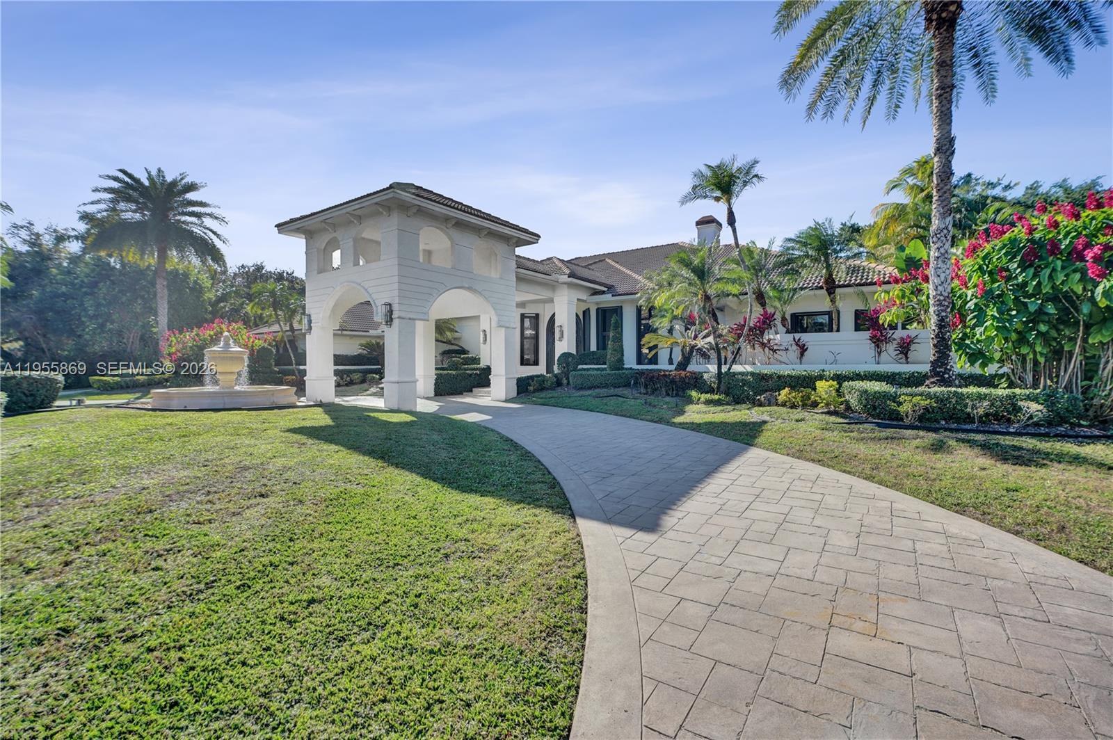 3175 Hunter Road Weston, FL 33331 - Photo 3 of 45 a front view of house with yard and green space