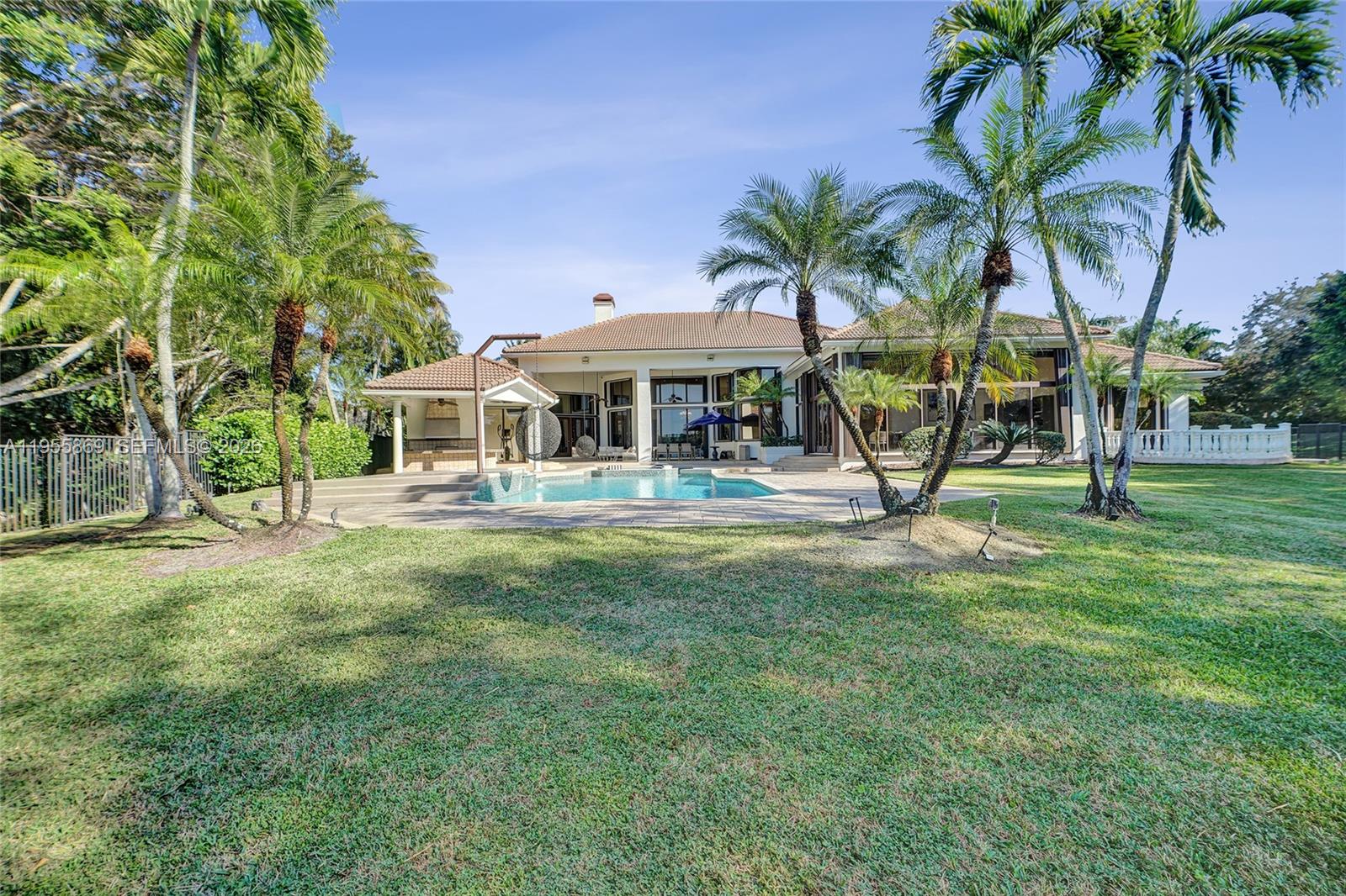 3175 Hunter Road Weston, FL 33331 - Photo 36 of 45 a view of a house with a yard patio and swimming pool