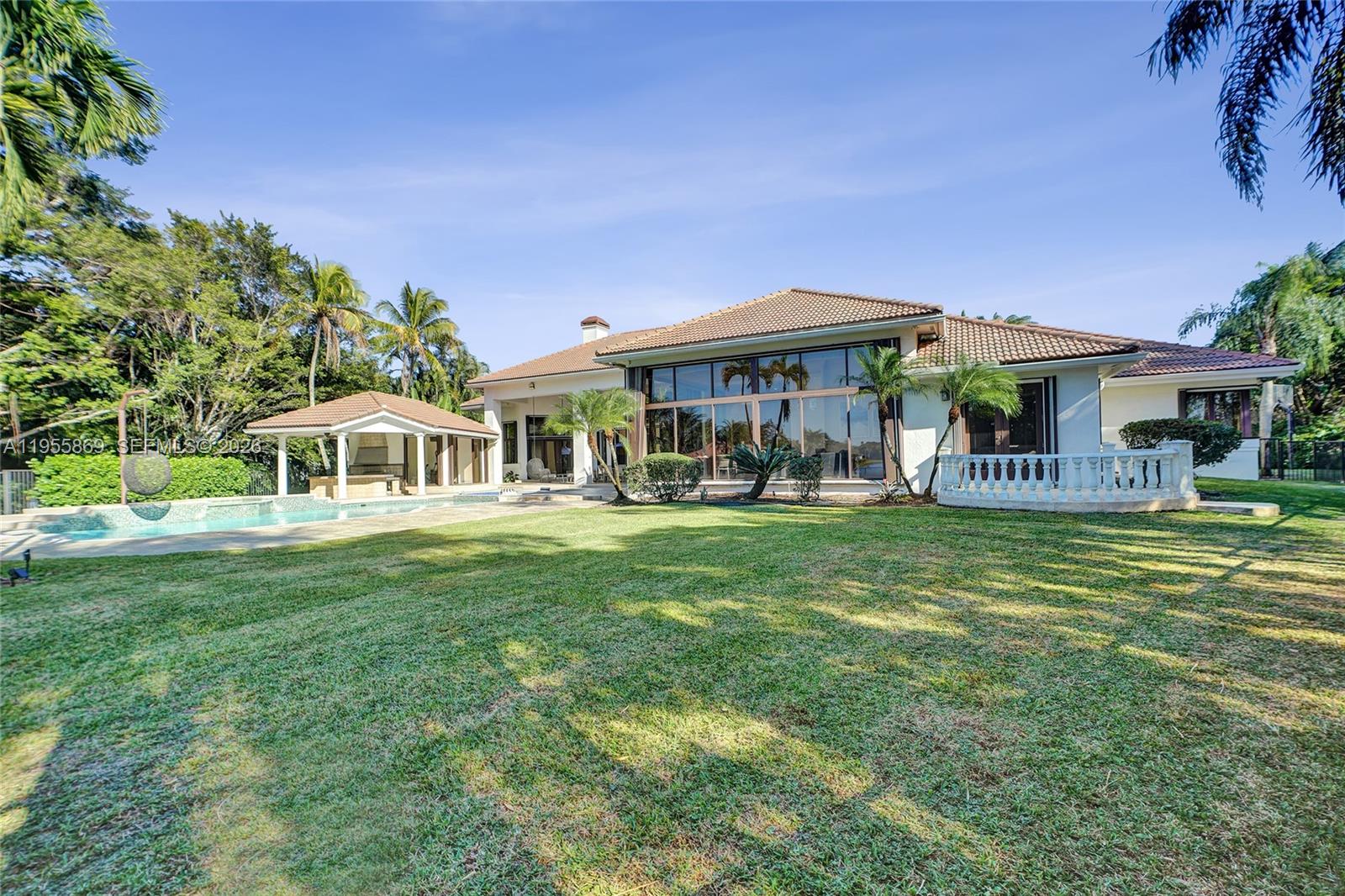 3175 Hunter Road Weston, FL 33331 - Photo 37 of 45 a front view of a house with a garden