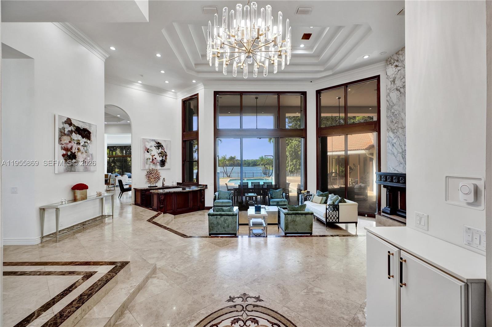 3175 Hunter Road Weston, FL 33331 - Photo 4 of 45 a living room with furniture large window and chandelier