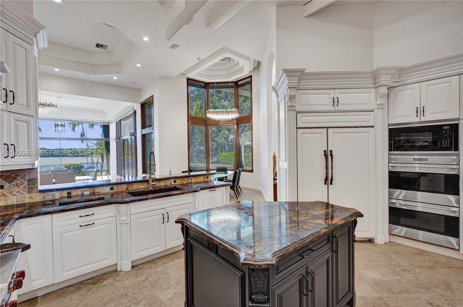 3175 Hunter Road Weston, FL 33331 - Photo 8 of 45 a kitchen with stainless steel appliances granite countertop a sink a stove and a refrigerator