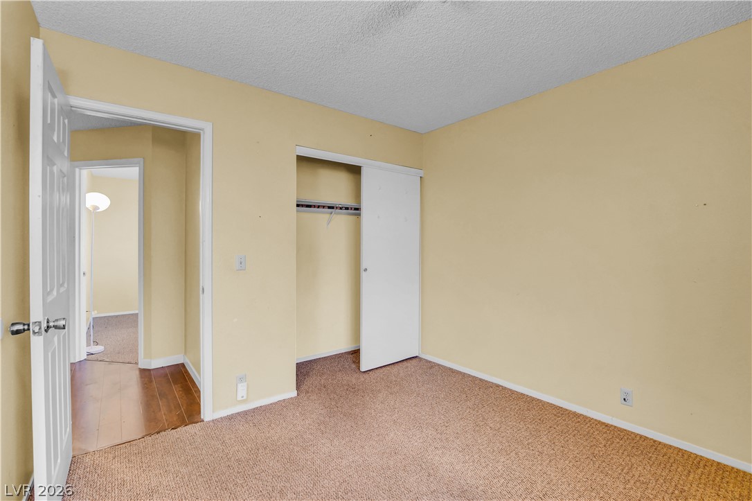 6440 Hartwood Road Las Vegas, NV 89108 - Photo 47 of 59 A well-lit bedroom featuring practical carpet flooring and a spacious closet.