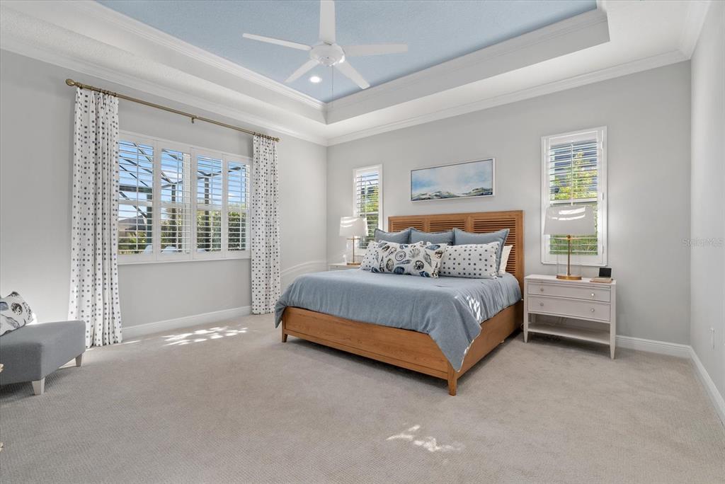 12480 Meribel Street Venice, FL 34293 - Photo 11 of 24 a bedroom with a bed lamp and a large window