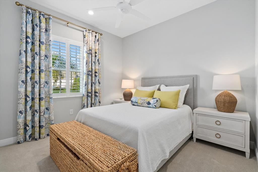 12480 Meribel Street Venice, FL 34293 - Photo 14 of 24 a bedroom with a bed and large window