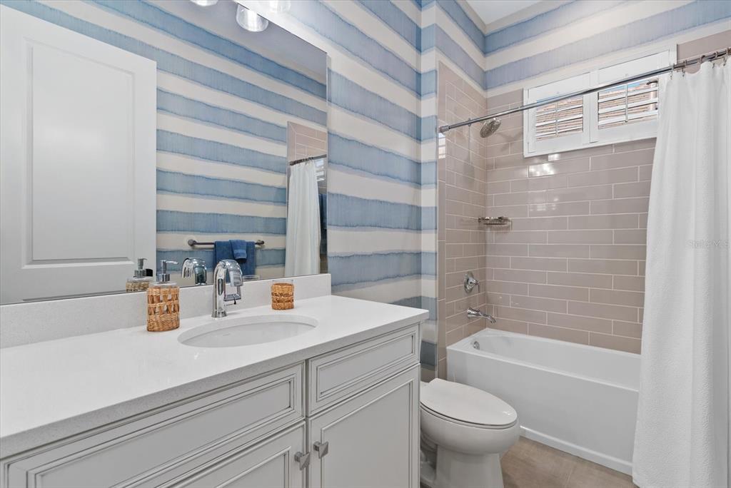 12480 Meribel Street Venice, FL 34293 - Photo 15 of 24 a bathroom with a sink a toilet and shower