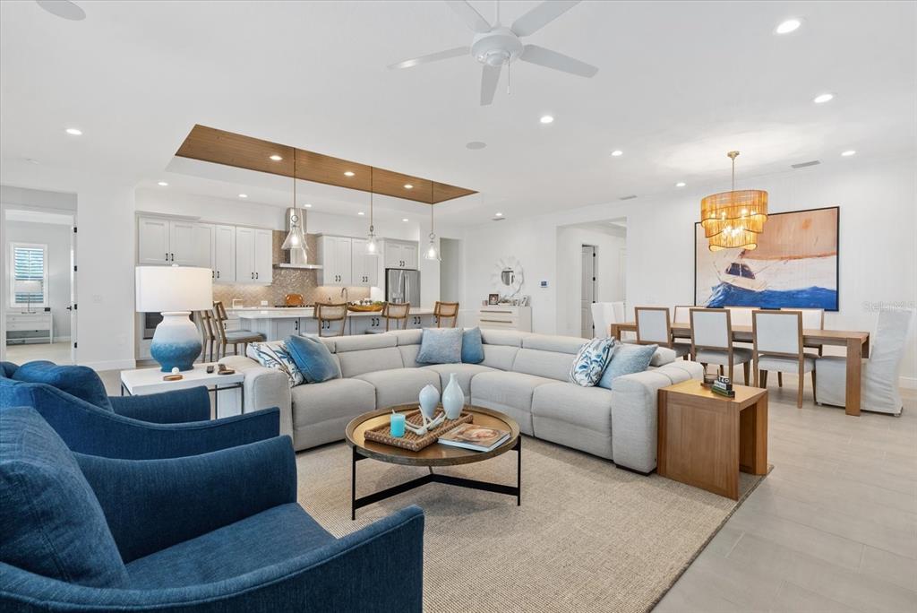 12480 Meribel Street Venice, FL 34293 - Photo 2 of 24 a living room with furniture and a ceiling fan