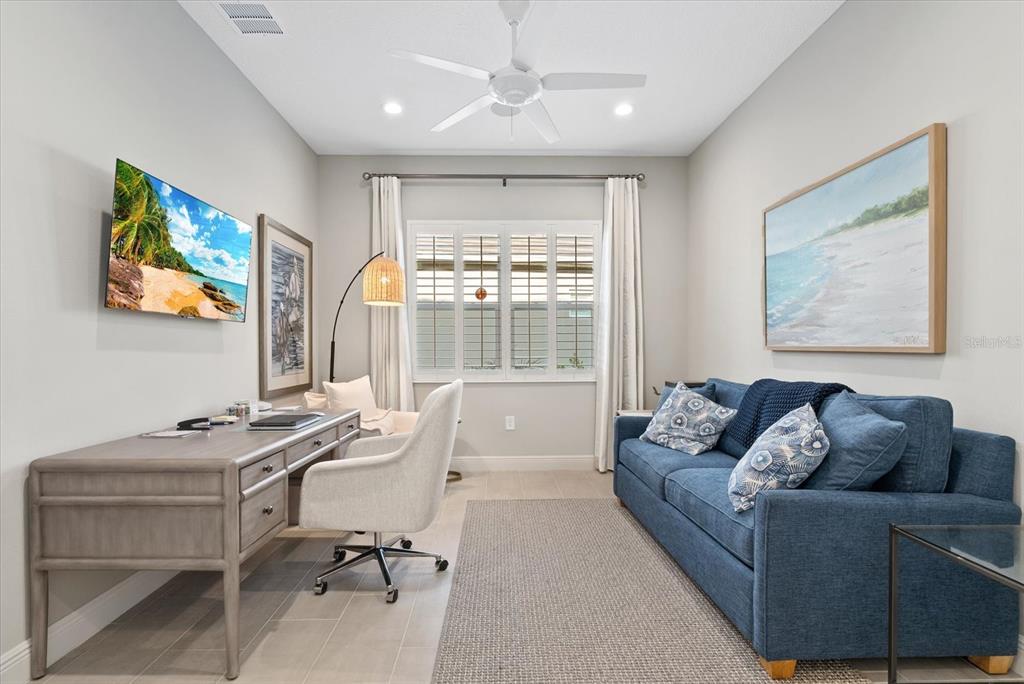 12480 Meribel Street Venice, FL 34293 - Photo 6 of 24 a living room with furniture flat screen tv and a window