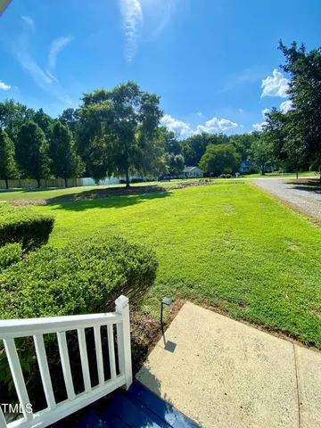 a view of a garden with wooden fence