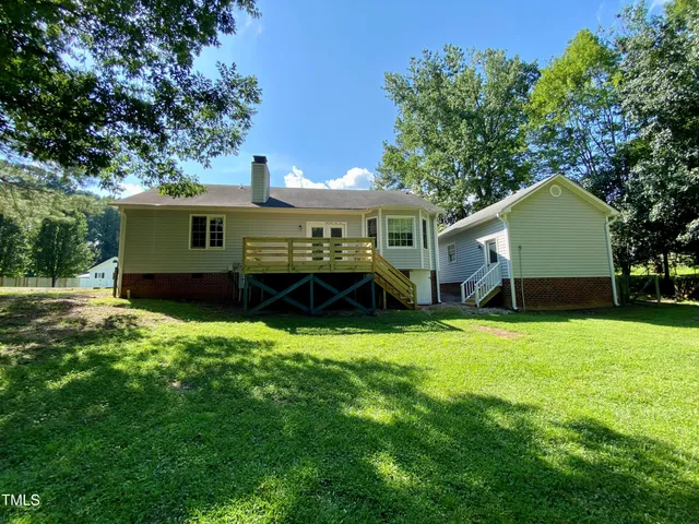 a front view of house with yard and trees