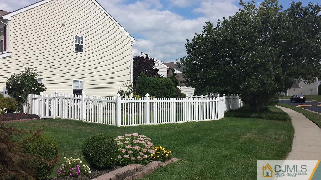 2 Brownstone Road East Windsor, NJ 08520 - Photo 18 of 18 a view of a white house with a small yard and a garden