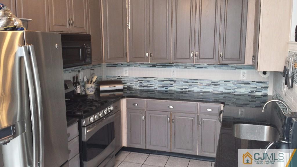 2 Brownstone Road East Windsor, NJ 08520 - Photo 6 of 18 a kitchen with stainless steel appliances granite countertop a stove a refrigerator and a sink