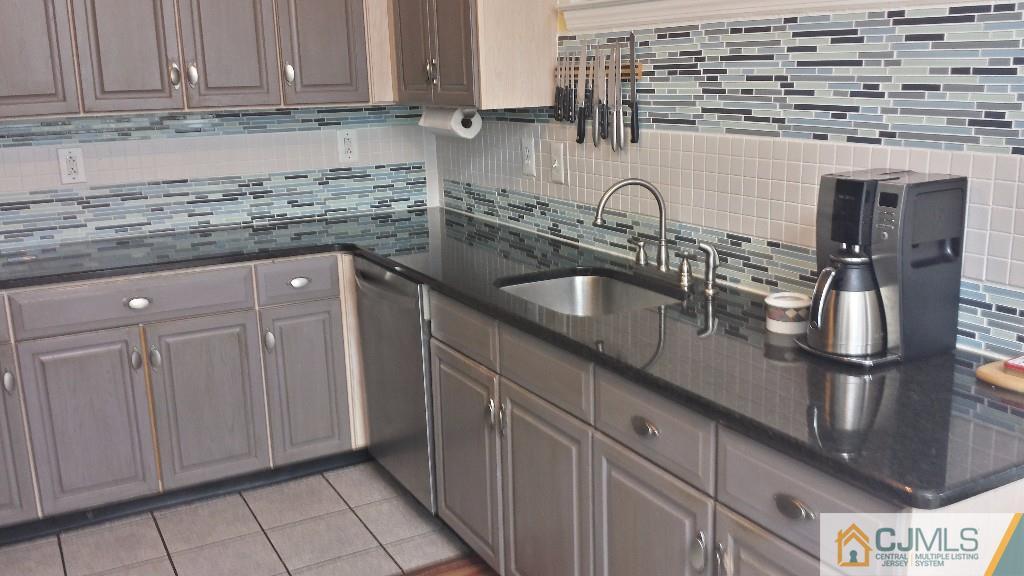 2 Brownstone Road East Windsor, NJ 08520 - Photo 7 of 18 a kitchen with stainless steel appliances granite countertop a sink and cabinets