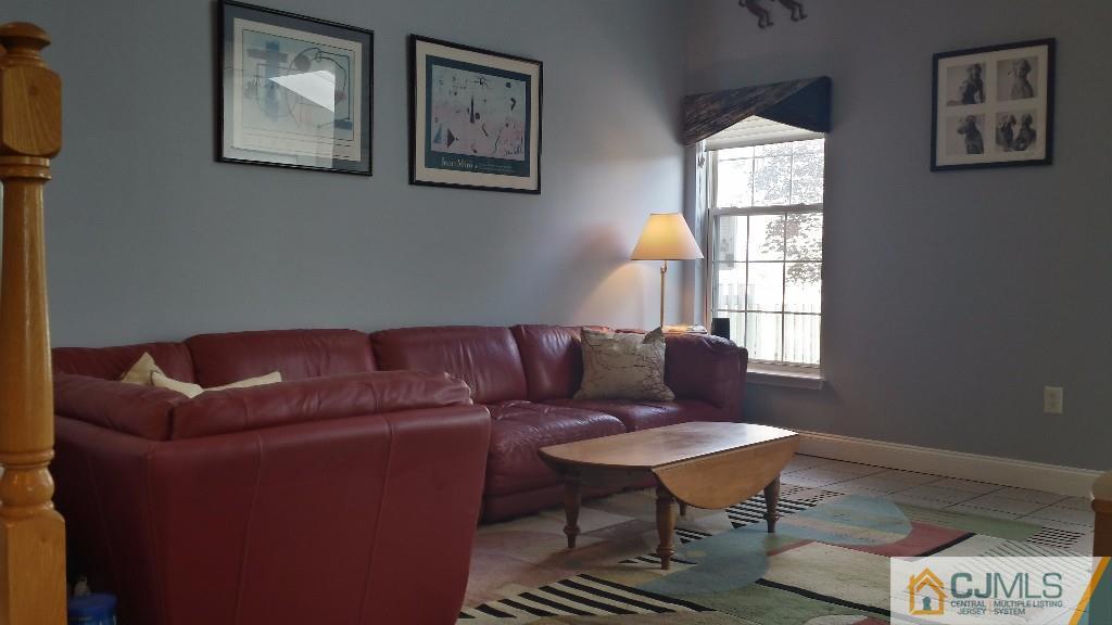 2 Brownstone Road East Windsor, NJ 08520 - Photo 9 of 18 a living room with furniture a window and a lamp