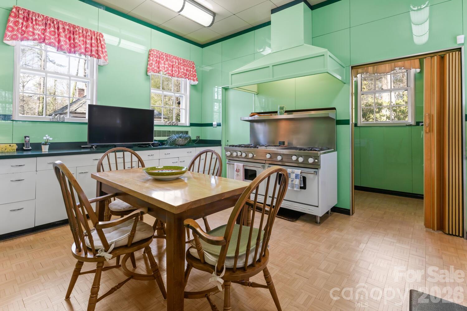 407 Vanderbilt Road Asheville, NC 28803 - Photo 22 of 48 a view of a dining room with furniture and a window